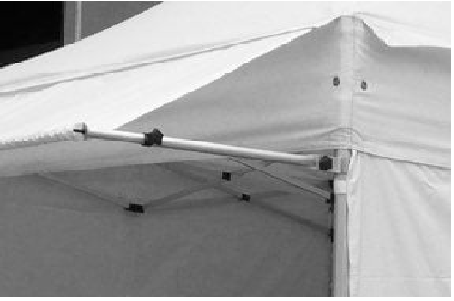 Close-up of a white canopy tent corner, showing the metal frame rods and joint fittings.
