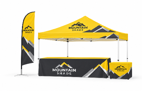Promotional outdoor booth with a yellow canopy and banners reading Mountain Shade in a trade show setup.