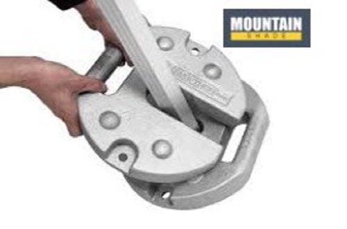 Hands using a metal pipe cutter to cut a metal pipe